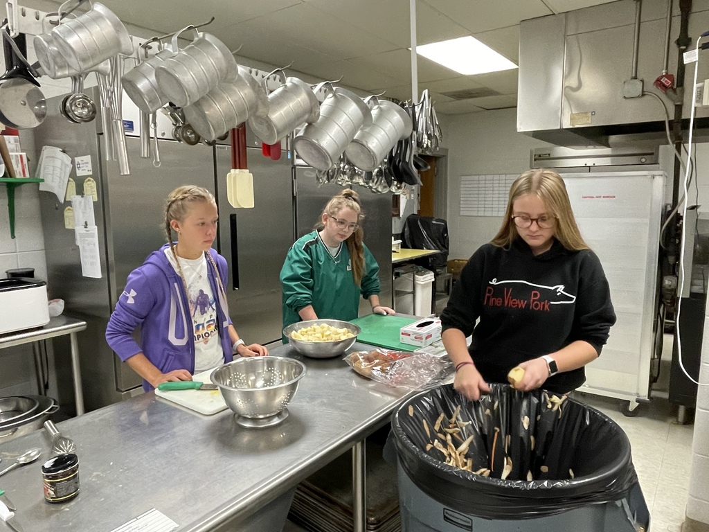 NHS students Claire Manring, Jocelyn Anthony and Brook Wink make vegetable soup for Senior Citizen Fun Night last Tuesday, October 25.